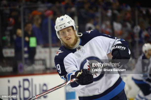 Patrik Laine of the Winnipeg Jets takes the shot in warm ups prior to the game against the New York Islanders at the Barclays Center on December 23,...