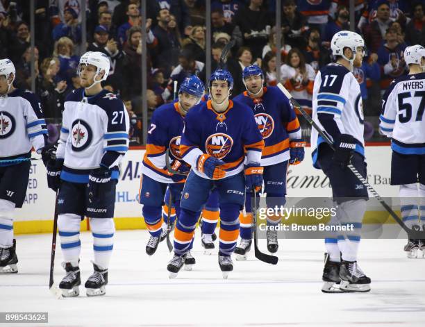 Mathew Barzal of the New York Islanders returns to the bench after scoring one of his three goals against the Winnipeg Jets at the Barclays Center on...