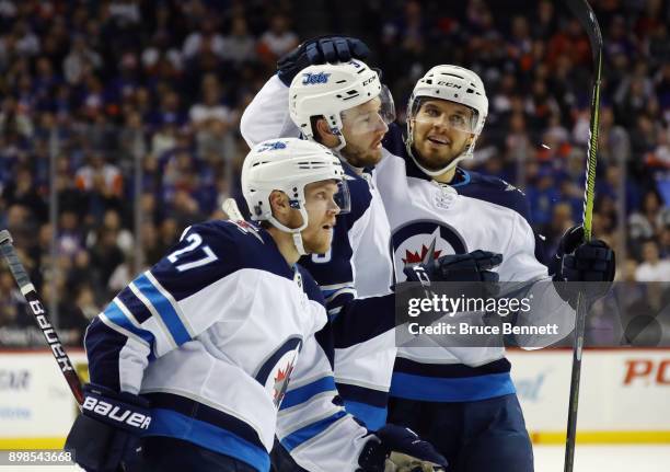 Tucker Poolman of the Winnipeg Jets celebrates his first NHL goal at 13:42 of the first period against the New York Islanders at the Barclays Center...