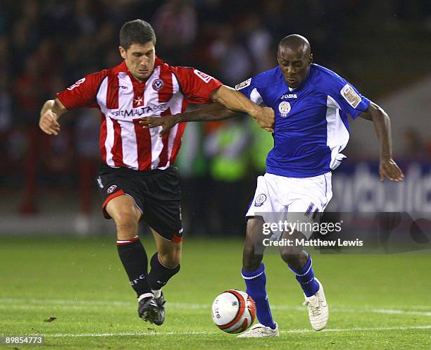 Lloyd Dyer of Leicester and Nick Montgomery of Sheffield challenge for the ball during the Coca-Cola Championship match between Sheffield United and...