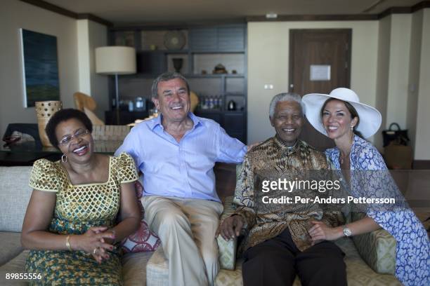 Former President Nelson Mandela of South Africa poses for pictures with his wife Graca Machel, Sol Kerzner and Heather Kerzner on April 2, 2009 at...
