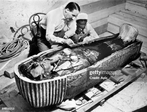 Howard Carter english egyptologist near golden sarcophagus of Tutankhamon in Egypt in 1922