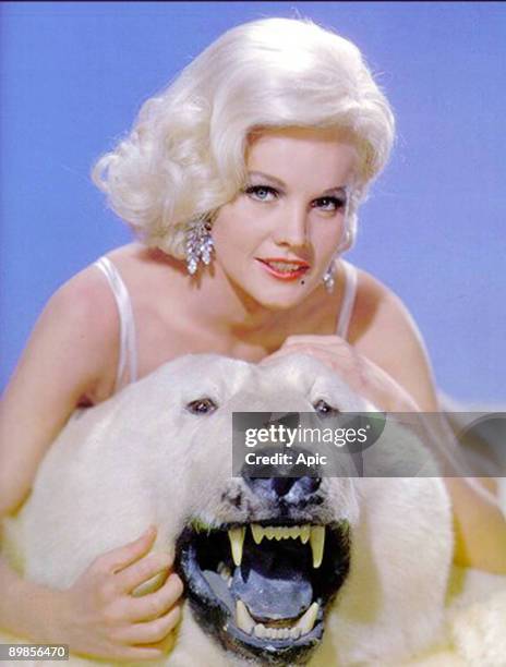 American actress Carroll Baker with stuffed polar bear c. 1964