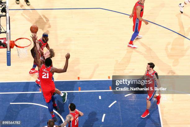 Ron Baker of the New York Knicks goes to the basket against the Philadelphia 76ers on December 25, 2017 at Madison Square Garden in New York City,...