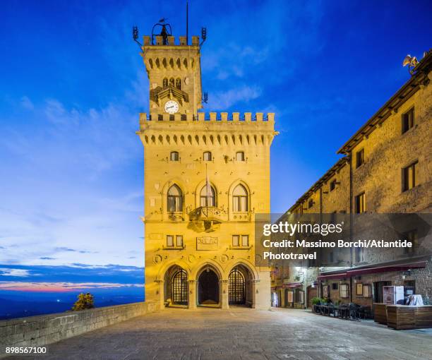 the public palace (town hall) at twilight - san marino stock-fotos und bilder