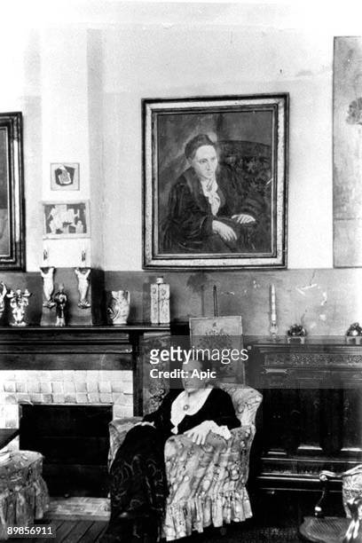 Gertrude Stein writer and art collector here at home, on the wall her portrait , c 1935