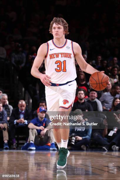 Ron Baker of the New York Knicks handles the ball against the Philadelphia 76ers on December 25, 2017 at Madison Square Garden in New York City, New...