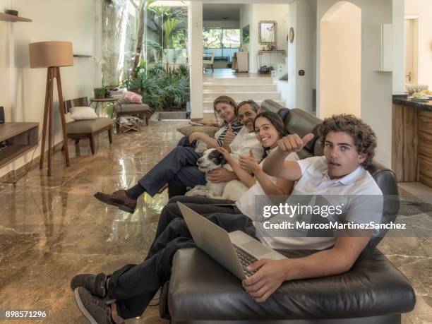 dog sitting quietly with family at leisure time in the living room - lypsesp17 stock pictures, royalty-free photos & images