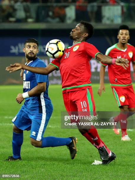 Kuwait's Redha Abo Jbarah vies for the ball with Oman's Mehsen Bin Jawhar during the 2017 Gulf Cup of Nations football match between Kuwait and Oman...