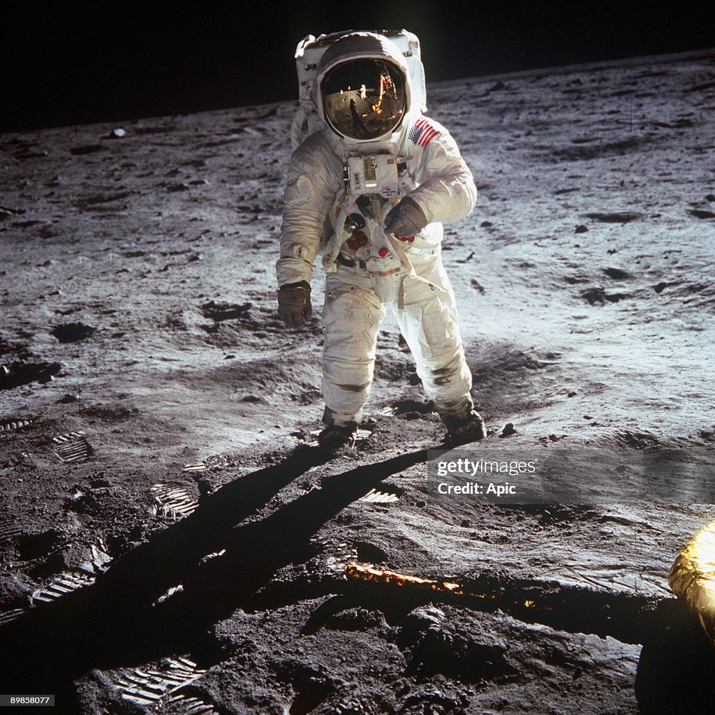 1st steps of human on Moon : american astronaut Edwin "Buzz" Aldrinwalking on the moon on july 20, 1969 during Apollo 11 mission (we see Neil Armstrong in the visor of the helmet)
