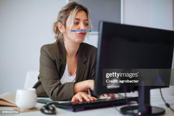 bored or incompetent businesswoman at work - girl in office stock pictures, royalty-free photos & images