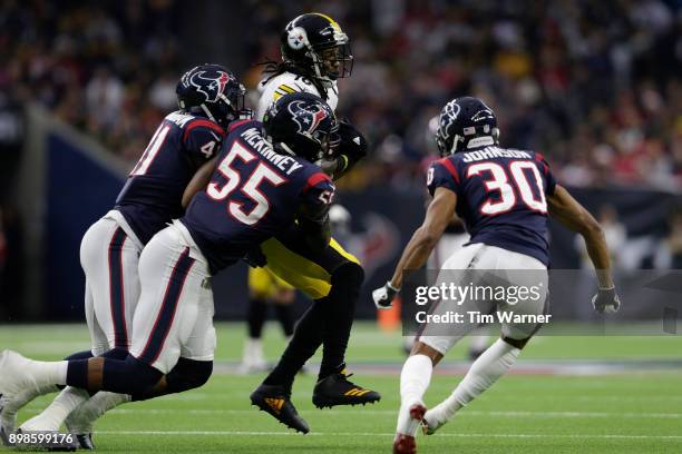 Martavis Bryant of the Pittsburgh Steelers catches a pass and is tackled by Zach Cunningham of the Houston Texans and Benardrick McKinney in the...