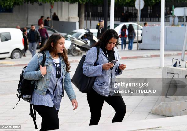 Tunisian students walk outside their school in Bizerte on November 23, 2017. In Tunisian high schools, the dress code is not uniform. Actually, it...