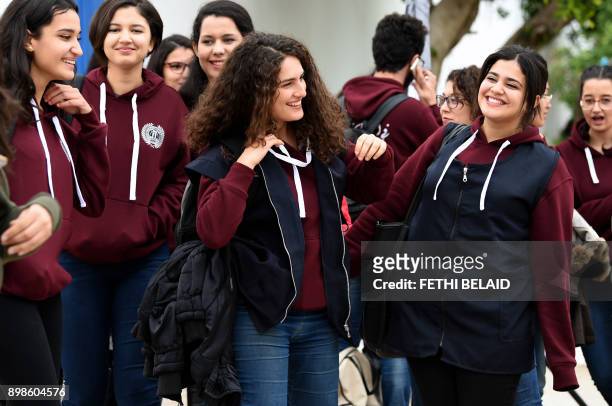 Siwar Tebourbi , an 18-year-old Tunisian schoolgirl, walks with colleagues as they leave school in Bizerte on November 30, 2017. In Tunisian high...