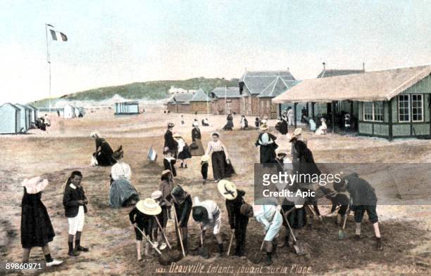 Children playing on the beach in Deauville, Normandy, France, postcard early 20th century