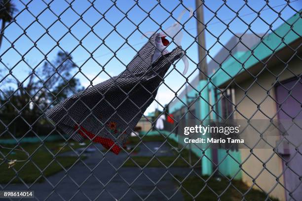 Girl's dress hangs to dry on a fence in a shelter for Hurricane Maria victims on Christmas day on December 25, 2017 in Toa Baja, Puerto Rico. 12...