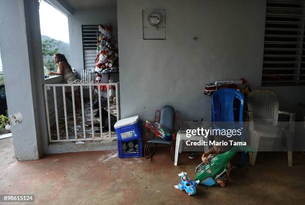 Young residents gather at their family's home, still without electricity, on Christmas day on December 25, 2017 in Morovis, Puerto Rico. The family...