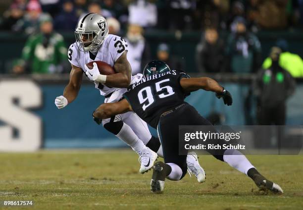 DeAndre Washington of the Oakland Raiders attempts to get past Mychal Kendricks of the Philadelphia Eagles after making a catch during the second...