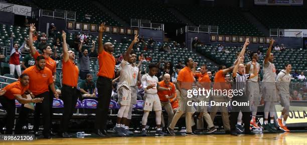 The Miami Hurricanes bench celebrates a basket during the second half of the 3rd place game of the Diamond Head Classic against the Middle Tennessee...