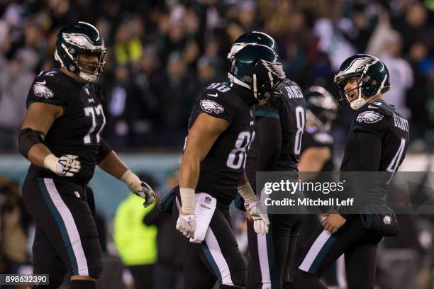 Jake Elliott of the Philadelphia Eagles celebrates with Trey Burton, Halapoulivaati Vaitai, and Donnie Jones after kicking the game winning field...