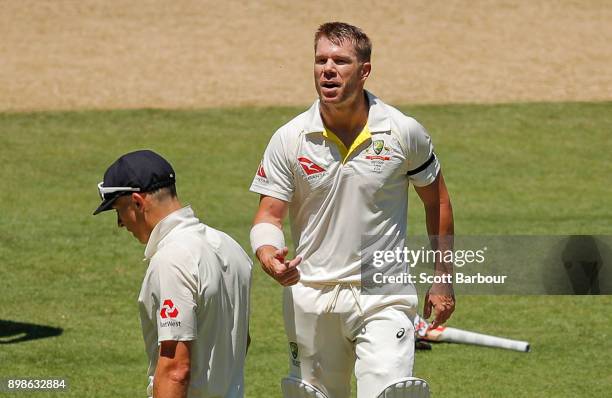 David Warner of Australia and bowler Tom Curran of England exchange words after Warner reached his century during day one of the Fourth Test Match in...