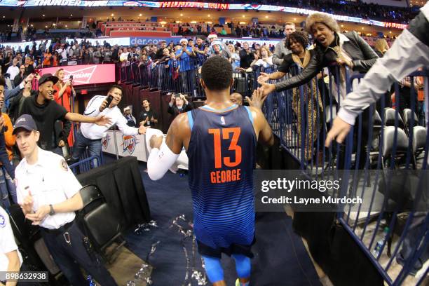 Paul George of the Oklahoma City Thunder high fives fans after the game against the Houston Rockets on December 25, 2017 at Chesapeake Energy Arena...