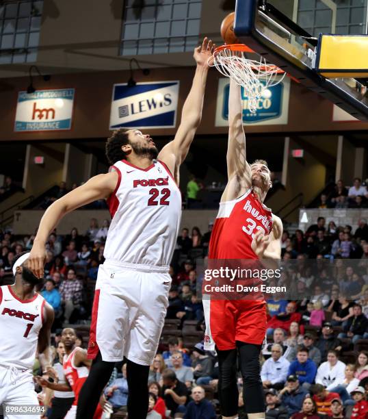 Austin Nichols of the Memphis Hustle battles for the rebound with A.J. Hammons of the Sioux Falls Skyforce during an NBA G-League game on December...