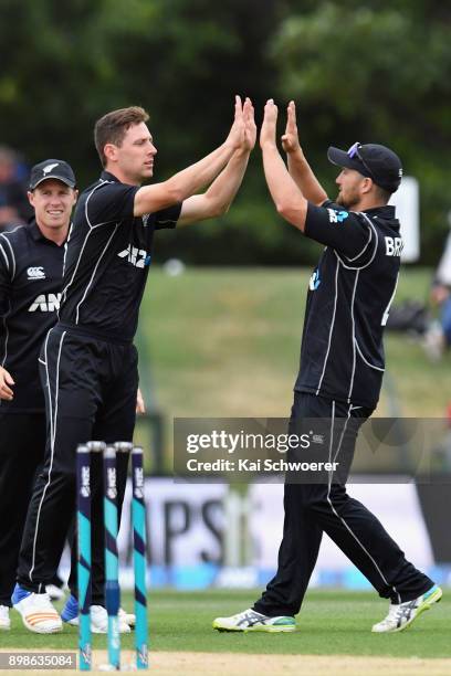 Matt Henry of New Zealand is congratulated by Neil Broom of New Zealand after dismissing Kyle Hope of the West Indies during the One Day...