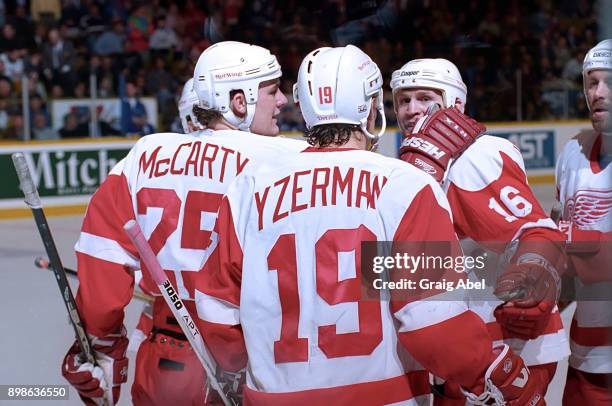 Darren McCarty, Steve Yzerman and Vladimir Konstantinov of the Detroit Red Wings celebrate their win over the Toronto Maple Leafs during NHL game...