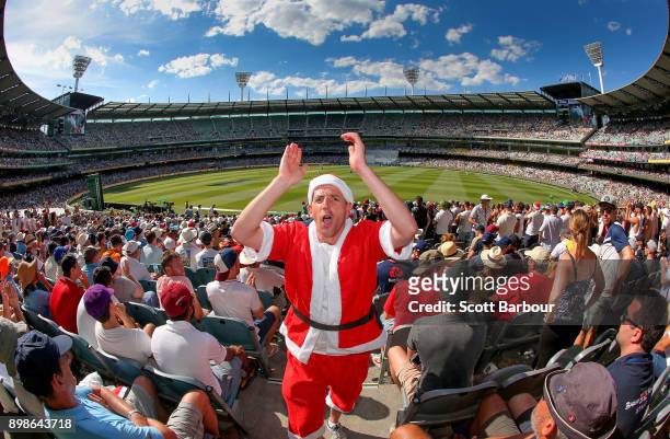 General view as a spectator dressed as Santa Claus enjoys the atmosphere in the crowd of 88,172 on Boxing Day during day one of the Fourth Test Match...