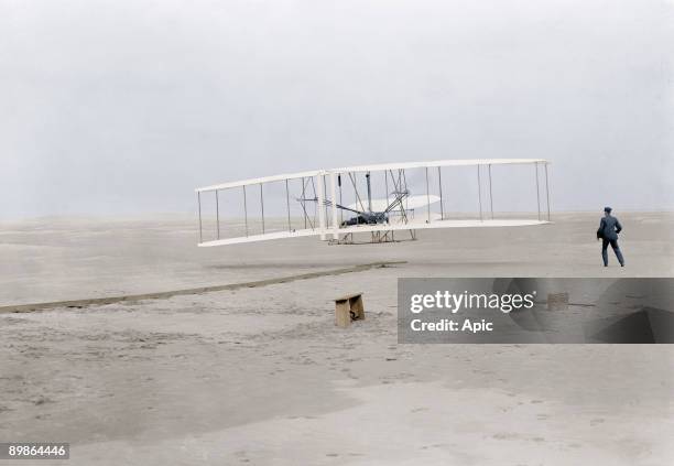 First flight of Orville Wright at Kill Devil Hills, Kitty Hawk, North Carolina december 17 his brother Wilbur Wright stand on the right