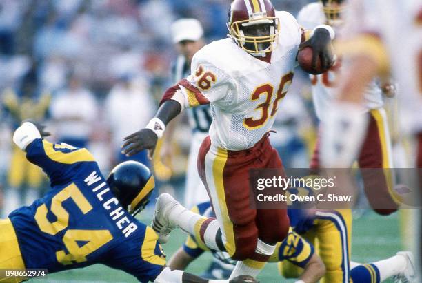 Timmy Smith of the Washington Redskins rushes against the Los Angeles Rams at Anaheim Stadium circa 1988 in Anaheim,California.