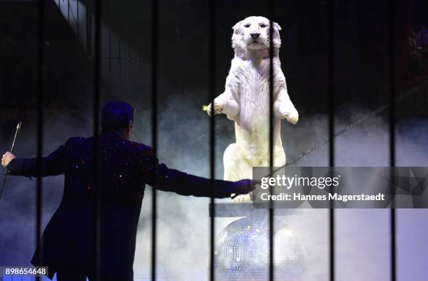 Hans-Ludwig Suppmeier performs with his white tiger Tibet during Circus Krone celebrates premiere of 'In Memoriam' at Circus Krone on December 25,...