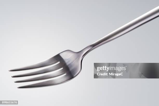 side shot of a silver colored fork - tenedor fotografías e imágenes de stock