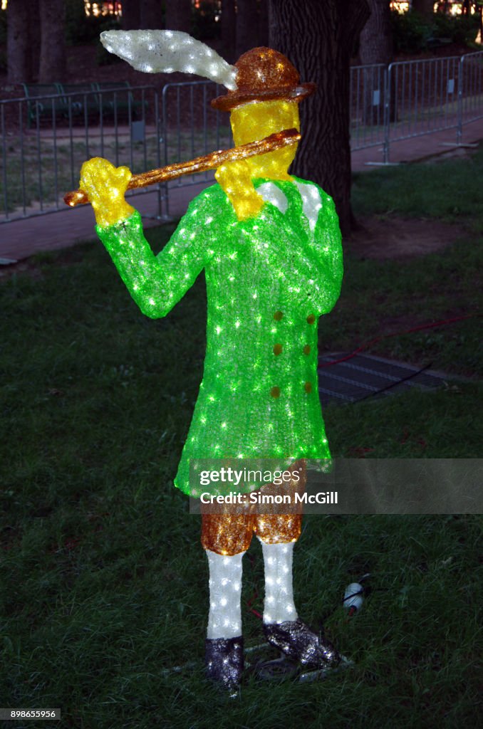 A statue of a piper piping at Christmas in Glebe Park, Glebe Park, Canberra City, Australian Capital Territory, Australia