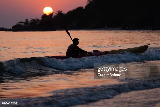 kayaks at the indian beach at sunset - palolem beach stock pictures, royalty-free photos & images