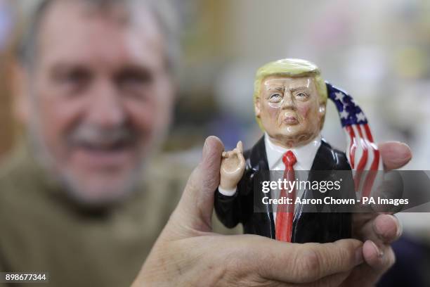 Roger Bairstow, owner of Bairstow Manor Pottery firm in Stoke-on-Trent, unveils a prototype of a Donald Trump Toby jug.