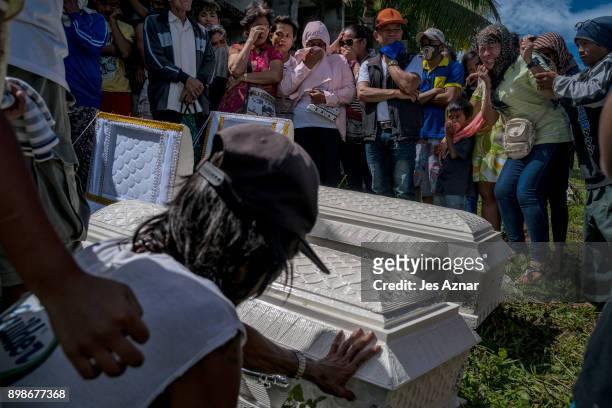 Family and friends mourn family members who perished during the onslought of tropical storm Tembin, on December 26, 2017 in Tubod, Lanao del Norte,...