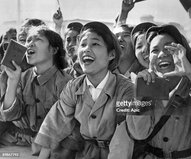 Members of red guards, holding The Little Red Book, cheering Mao Zedong during a meeting to celebrate the Great Proletarian Cultural Revolution on...