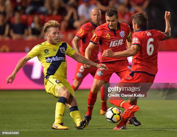 Andrew Hoole of the Mariners and Vince Lia of United compete for the ball during the round 12 A-League match between Adelaide United and the Central...