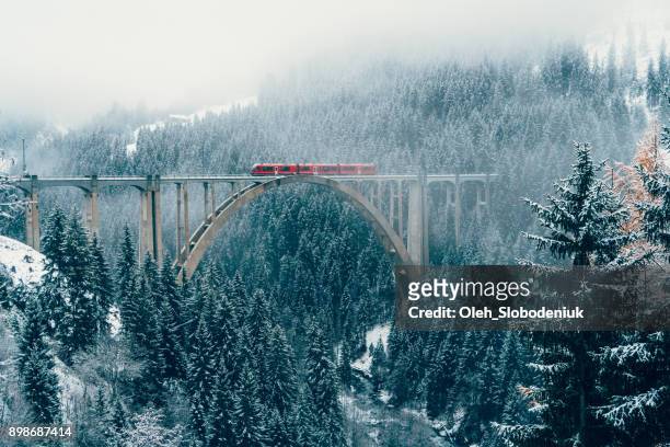 scenic view of train on viaduct in switzerland - european alps stock pictures, royalty-free photos & images