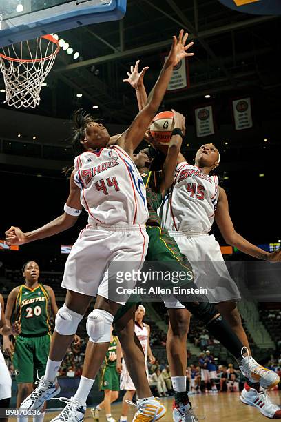 Swin Cash of the Seattle Storm is doubled by Taj McWilliams and Kara Braxton of the Detroit Shock at The Palace of Auburn Hills August 18, 2009 in...