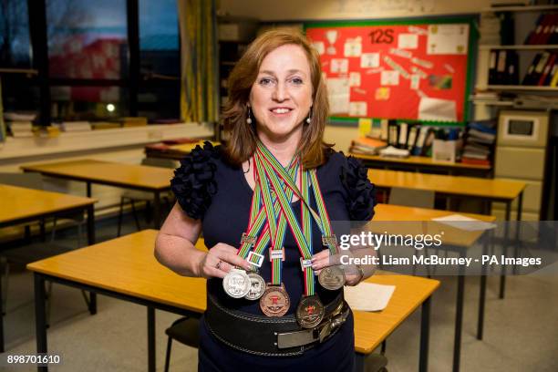 Lucille Rowan who teaches mathematics at St Malachy's High School in rural Co Down, holding the Commonwealth powerlifting medals that she won in...