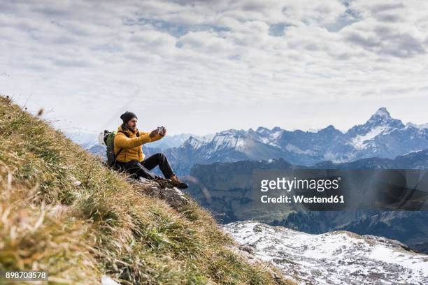 germany, bavaria, oberstdorf, hiker taking picture in alpine scenery - casual clothing photos stock-fotos und bilder