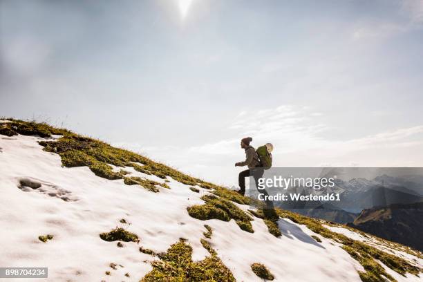 germany, bavaria, oberstdorf, man walking up alpine meadow - meta turistica fotografías e imágenes de stock