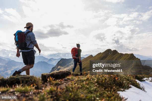 germany, bavaria, oberstdorf, two hikers walking on mountain ridge - bayern menschen stock-fotos und bilder