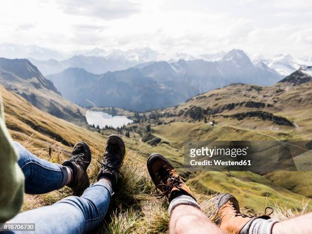 germany, bavaria, oberstdorf, legs of two hikers resting in alpine scenery - wanderschuhe stock-fotos und bilder