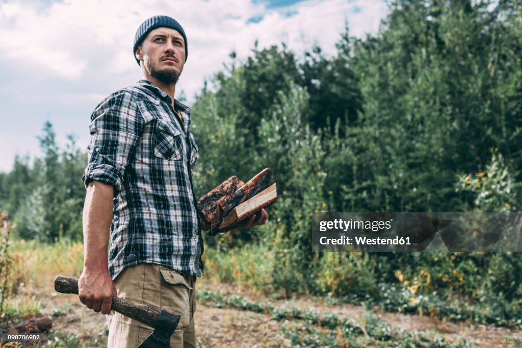 Man chopping wood in rural landscape