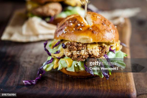 vegetarian burger with fried cauliflower, lettuce and curry sauce - veggie burger stock pictures, royalty-free photos & images