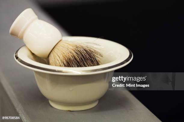 a traditional ceramic shaving bowl and shaving brush. - pennello da barba foto e immagini stock